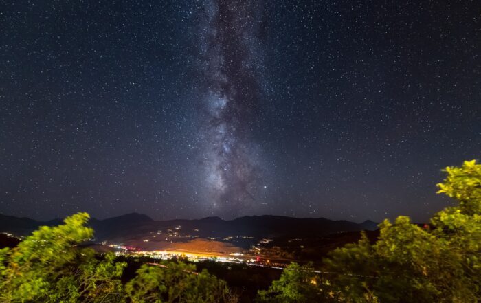 dark starry sky over city lights